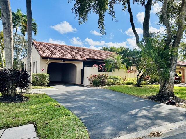 ranch-style house with a front yard and a garage