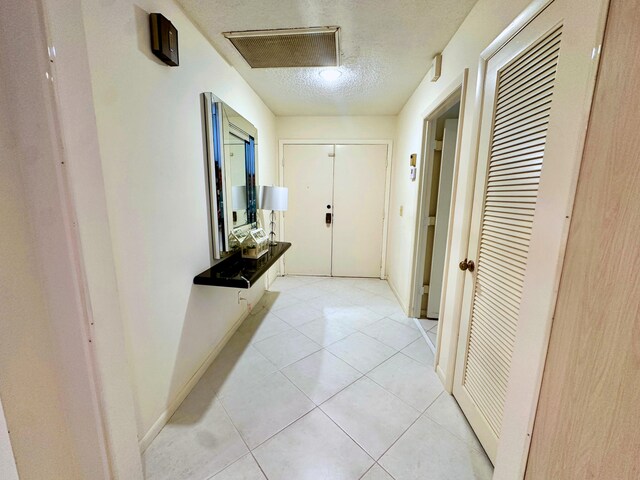 kitchen featuring decorative backsplash, white cabinets, white appliances, and light tile patterned floors