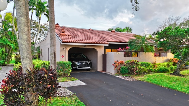 mediterranean / spanish home featuring a garage