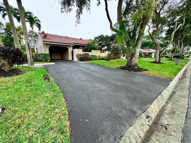 view of front of house featuring a garage and a front lawn