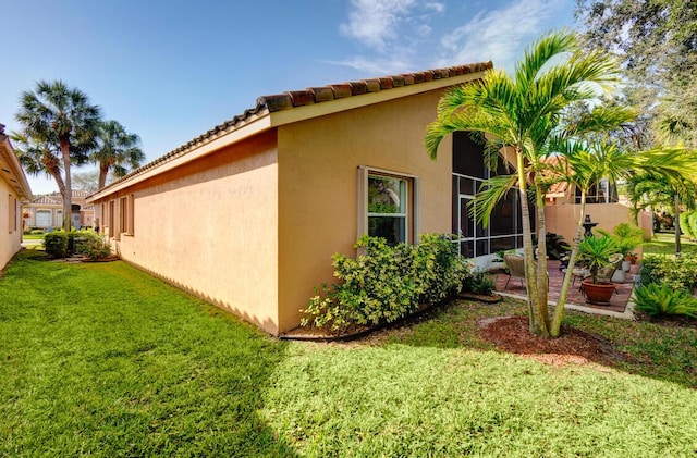 view of home's exterior with a lawn