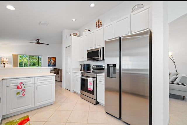 kitchen with light tile patterned floors, ceiling fan, white cabinets, and appliances with stainless steel finishes