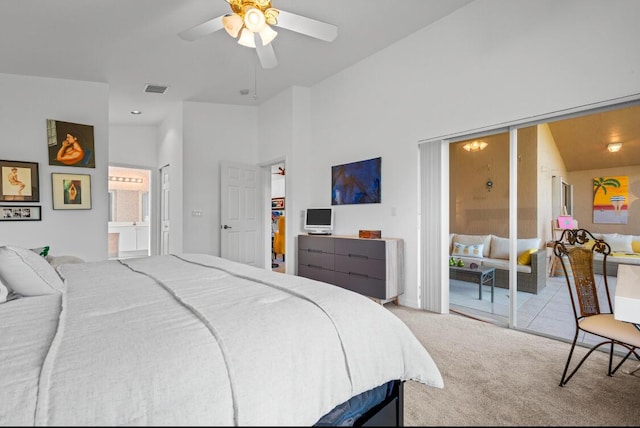 carpeted bedroom with a high ceiling, ceiling fan, and ensuite bathroom