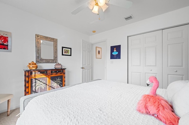 carpeted bedroom with a closet and ceiling fan