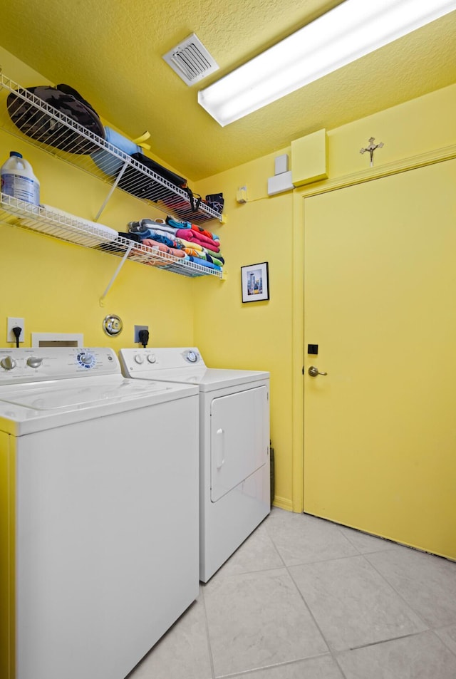 washroom featuring light tile patterned floors and washer and dryer