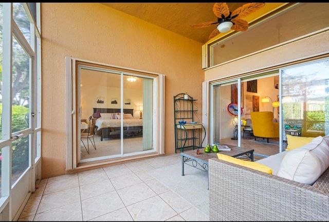 sunroom with lofted ceiling and ceiling fan