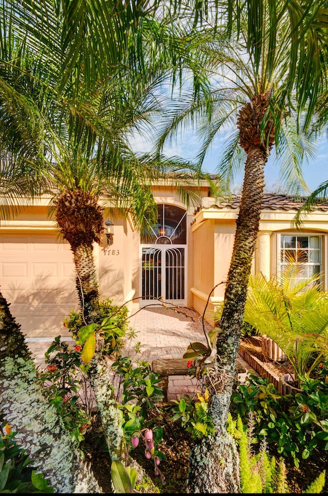 rear view of property featuring a garage