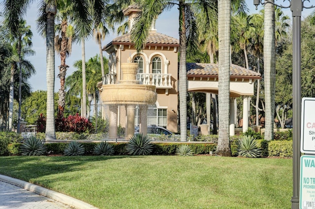 mediterranean / spanish-style house featuring a front yard