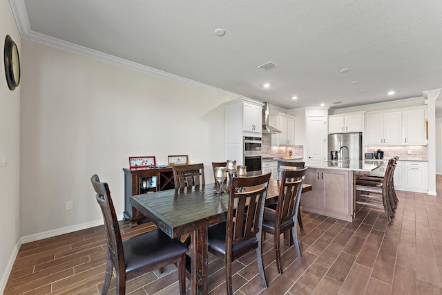 dining space with crown molding