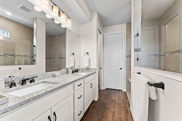 bathroom featuring walk in shower and vanity