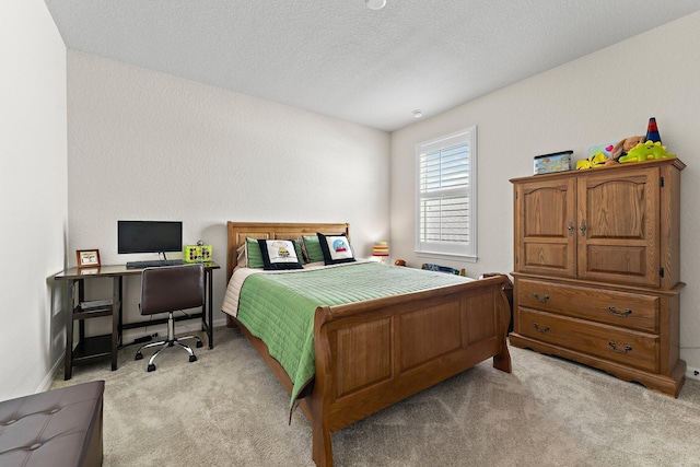 bedroom featuring a textured ceiling and light carpet