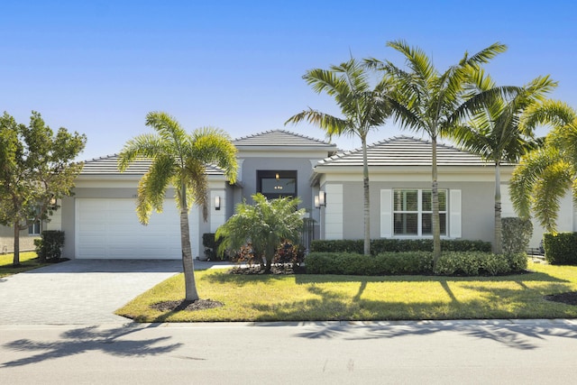 view of front of house featuring a front yard and a garage