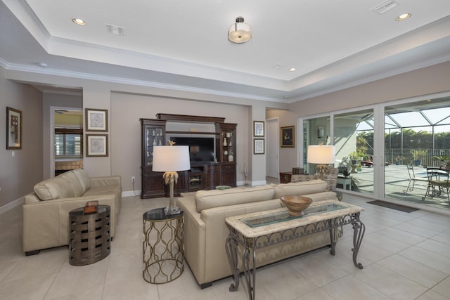 tiled living room featuring a raised ceiling