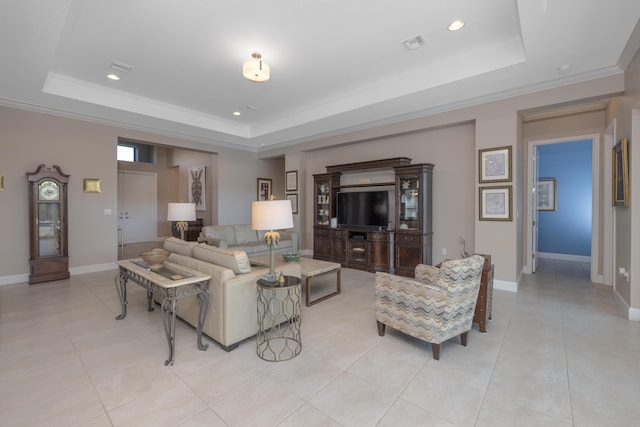 tiled living room featuring a tray ceiling and crown molding