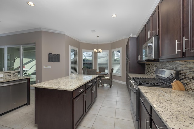 kitchen with a center island, decorative light fixtures, stainless steel appliances, an inviting chandelier, and backsplash