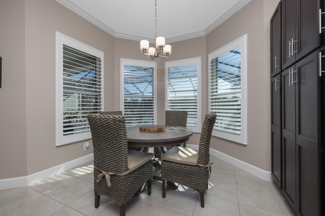 tiled dining space featuring a notable chandelier, ornamental molding, and a wealth of natural light