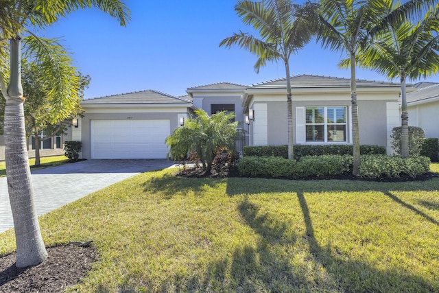 view of front of property with a front lawn and a garage