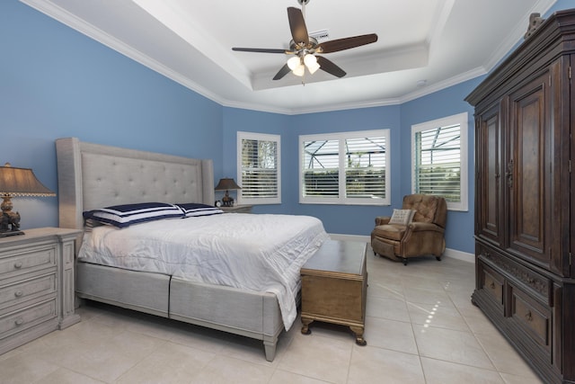 tiled bedroom with ceiling fan, ornamental molding, and a tray ceiling