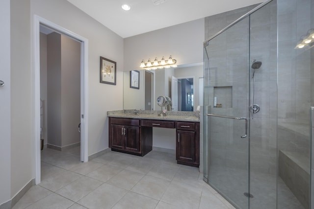 bathroom featuring an enclosed shower, vanity, and tile patterned floors