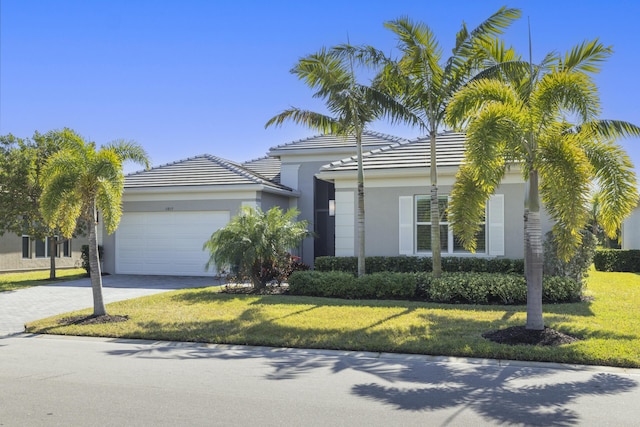 view of front of house with a front yard and a garage