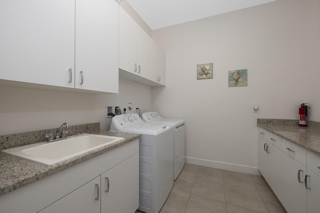 clothes washing area with sink, cabinets, independent washer and dryer, and light tile patterned floors