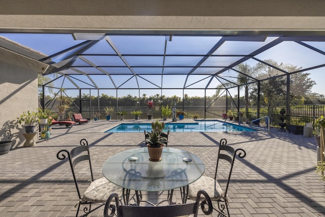 view of pool featuring a patio and glass enclosure