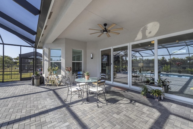 view of patio featuring ceiling fan and a lanai