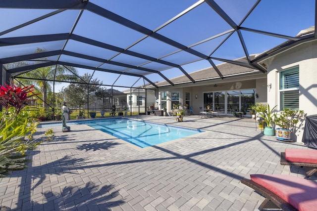 view of pool featuring a lanai, ceiling fan, and a patio