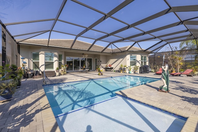 view of pool featuring a lanai, ceiling fan, and a patio area