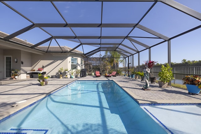 view of swimming pool featuring a lanai and a patio area