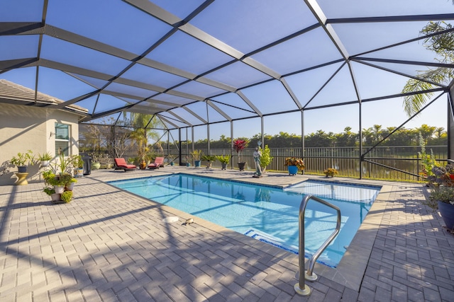 view of swimming pool with a lanai and a patio area