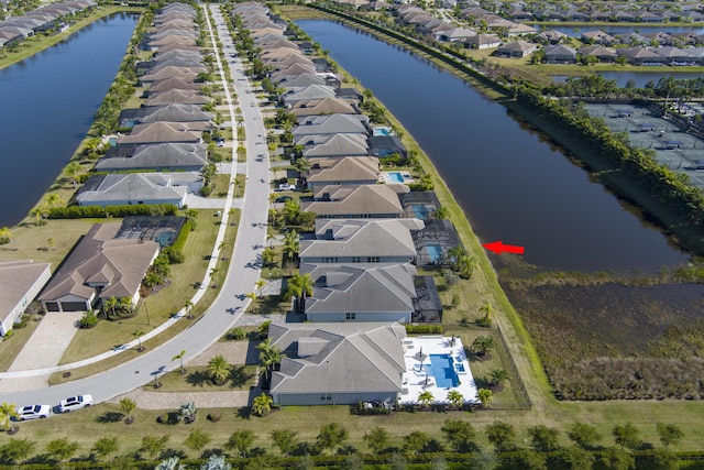 birds eye view of property with a water view