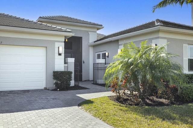 doorway to property with a garage