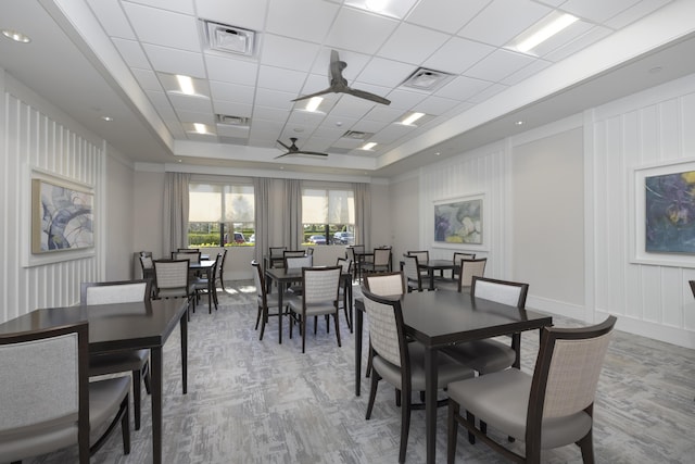 dining room featuring a paneled ceiling, carpet flooring, ceiling fan, and a tray ceiling