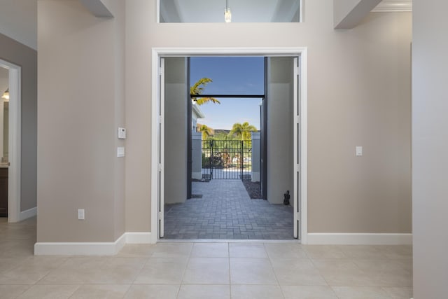 foyer entrance featuring ornamental molding and light tile patterned floors