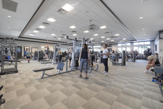 workout area featuring light colored carpet and a drop ceiling