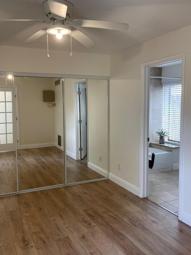 unfurnished bedroom featuring ceiling fan and wood-type flooring