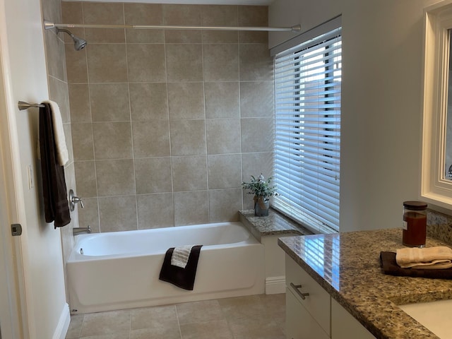 bathroom featuring vanity, tiled shower / bath combo, and tile patterned floors