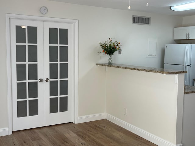 interior space with french doors and dark hardwood / wood-style floors