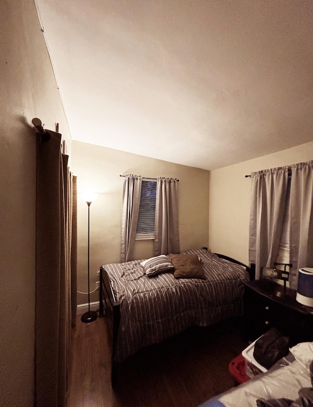 bedroom featuring lofted ceiling and wood-type flooring