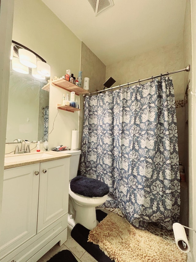 bathroom featuring vanity, curtained shower, and toilet