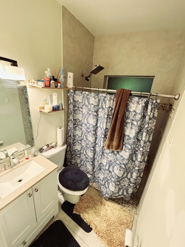 bathroom featuring vanity, tile patterned flooring, toilet, and walk in shower