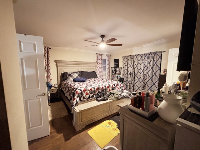 bedroom with crown molding, dark wood-type flooring, and ceiling fan