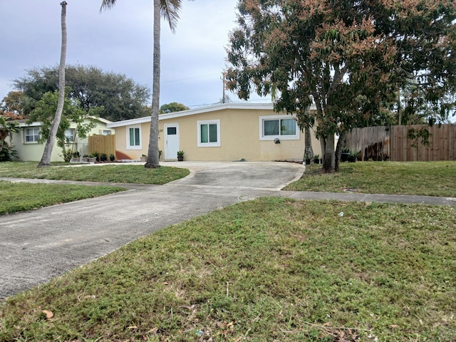 ranch-style house with a front lawn