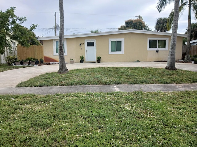 ranch-style home featuring a front yard