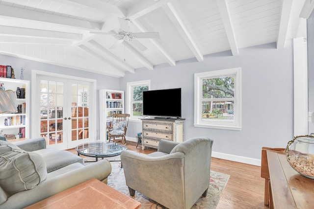 living room featuring light hardwood / wood-style floors, ceiling fan, french doors, and vaulted ceiling with beams