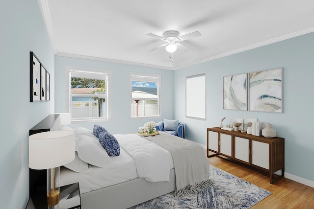 bedroom featuring ceiling fan, ornamental molding, and light hardwood / wood-style floors