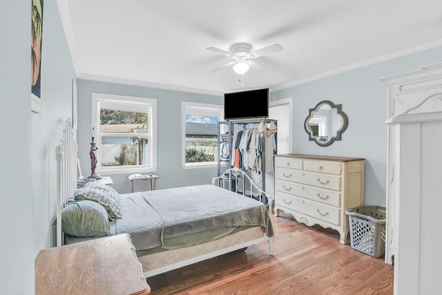 bedroom with ceiling fan, hardwood / wood-style flooring, and crown molding