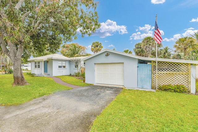 single story home featuring a front lawn and a garage