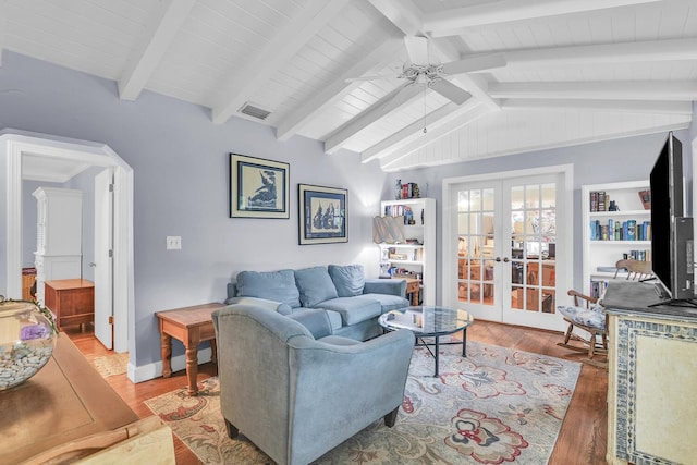 living room featuring ceiling fan, hardwood / wood-style floors, french doors, and vaulted ceiling with beams